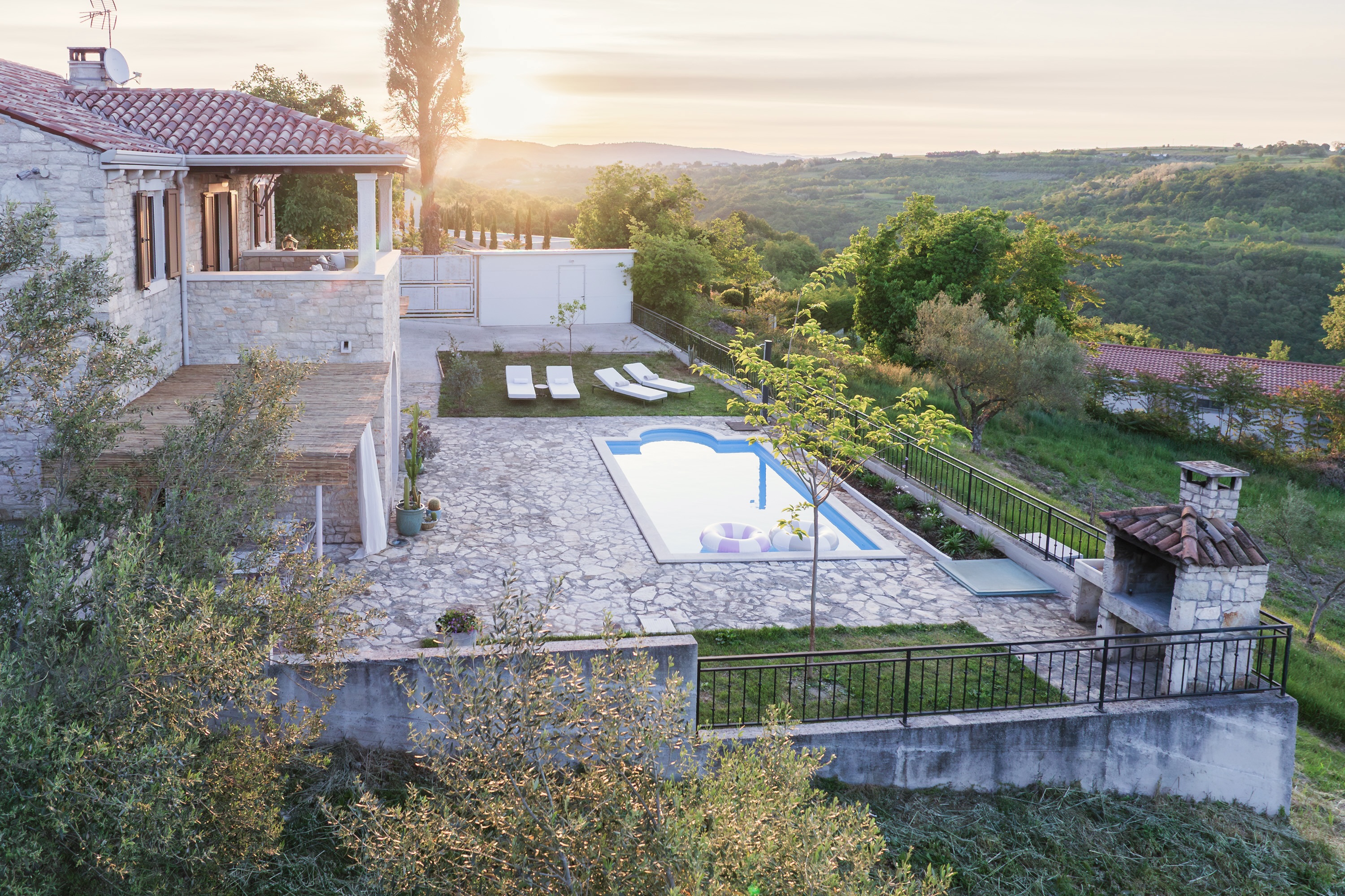 Casa Priani stone villa with illuminated pool at night, Istria